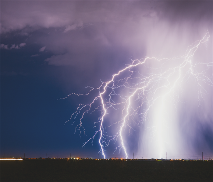 Lightning bolt strike from a thunderstorm over a city